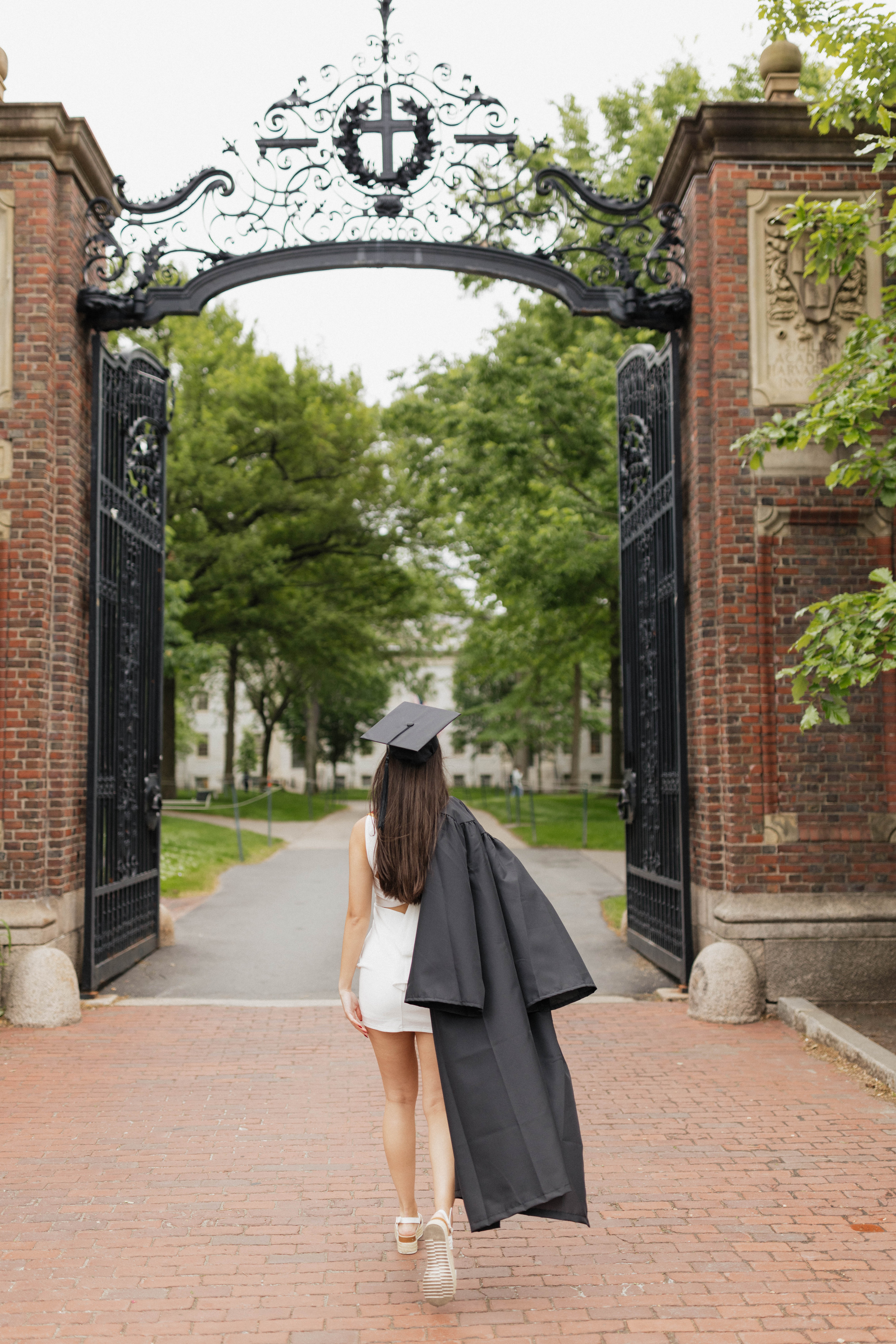 Helen walking through Harvard's Johnston Gate